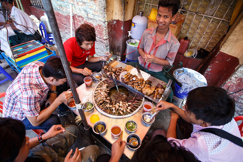 Picture of locals eating street food in Yangon, Myanmar